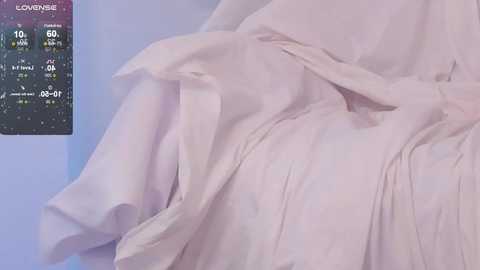 Media: Video of a pale, wrinkled, loose-fitting fabric, likely a hospital gown, with a digital thermometer displaying 96.7\u00b0F and 10:01 AM in the upper left corner.