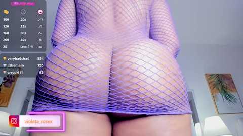 Media: Video of a woman in a purple fishnet bodysuit, highlighting her curvy, bare buttocks, taken from a low angle. Background shows a modern room with minimalist decor. Social media app interface overlaid with stats.