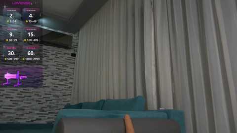 Media: Video of a modern living room with teal sofa, beige curtains, and a textured gray wall. A digital screen displays a virtual piano with glowing pink notes.