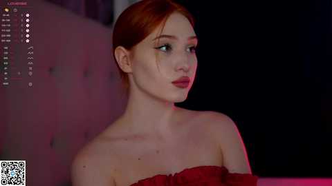 Media: A video of a fair-skinned redhead woman with red lipstick, wearing a red off-shoulder dress, set against a dark background with a QR code watermark.