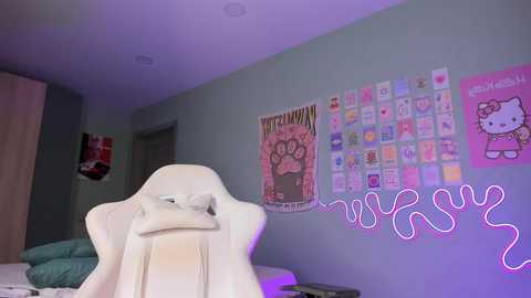 Media: Video of a modern bedroom with light blue walls, featuring a white gaming chair, a pink Hello Kitty wall mural, and a neon \"MAY\" sign.