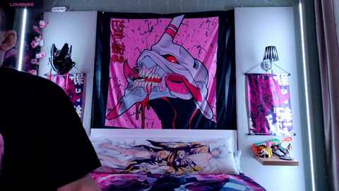 Media: Video of a teenager's bedroom with a pink, black, and white color scheme. A large, vibrant, anime-style poster of a monster dominates the wall. A black lampshade hangs on the left.