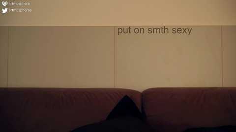 Media: A video of a dimly lit beige couch with a black cushion and a \"put on smith sex\" text on a beige wall, accompanied by a watermark.