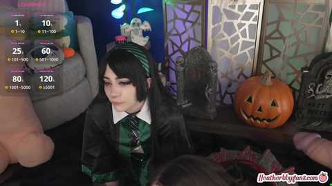 Media: A video depicts a young woman with pale skin, black hair, and a green and black Hogwarts School uniform, surrounded by Halloween decorations and a pumpkin.