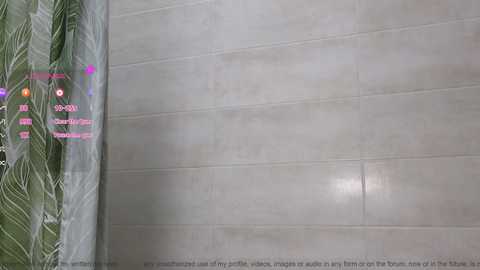 Media: Video of a modern bathroom with large, light gray tiled walls and a leaf-patterned shower curtain on the left. A digital overlay shows a QR code and text, suggesting a virtual tour or interactive element.