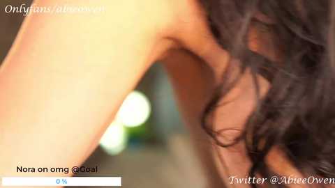 Media: Video of a dark-haired woman, possibly of Asian descent, leaning forward with her hair obscuring her face, in a warm, soft-focus setting. Text overlays include \"OnlyFans @alibabesven\" and \"Twitter @ArieeOvee.\