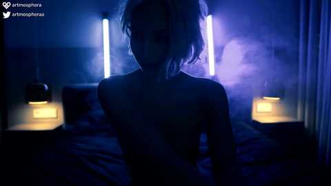 Media: A video of a nude woman with a dark silhouette, standing in a dimly-lit bedroom with blue lighting, and a bed with two bedside lamps.