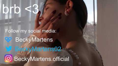 Media: Video of a young woman with long black hair, wearing a white dress, covering her eyes with her hands. Text overlay reads \"Follow my social media,\" with social media icons.