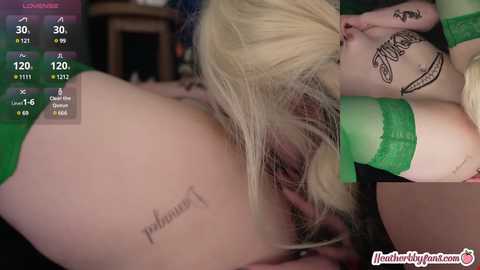 Media: Video featuring a close-up of a blonde woman's exposed buttocks, revealing a tattoo of a musical note, and a tattoo on her forearm.