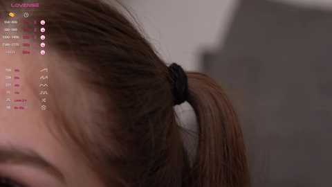 Media: A close-up video of a woman's head with a brown ponytail, showing a blurred, neutral-colored background and a \"Gaming\" app interface on the left side.