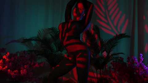 Media: Video of a nude woman with dark skin, black hair, and large breasts, posing sensually in a lush jungle setting with red and blue lighting, surrounded by vibrant green foliage and red flowers.