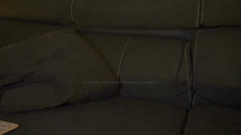 Media: Video of a dark green leather sofa with visible seams, showing a close-up view of the cushioned surface.