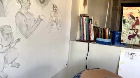 Media: A video of an artist's messy studio with a white wall covered in pencil sketches, a bookshelf filled with art books, a monitor displaying an anime scene, and scattered papers on a table.