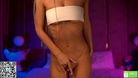 Media: Video of a slender, light-skinned woman with long platinum hair, wearing a white bandeau top and no pants, standing in a dimly-lit bedroom with purple and blue lighting.