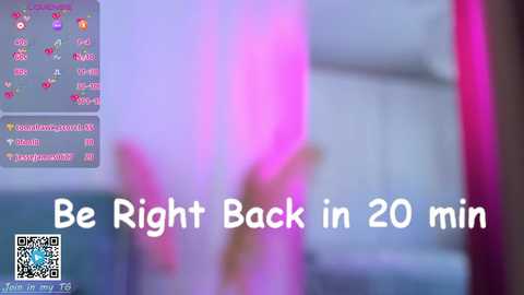 Media: A blurred video with a pink background features a text overlay that reads, \"Be Right Back in 20 min,\" accompanied by a QR code. The image is likely taken from a live stream or video chat.