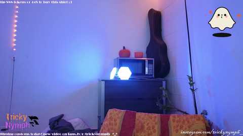 Media: A video of a dimly lit room with a dark TV, a guitar, and a pumpkin on a shelf, featuring a \"Frankie's Mymp\" watermark.