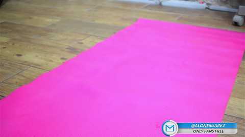 Media: Video of a bright pink yoga mat on a wooden floor, with a watermark at the bottom right corner stating \"REALONESAREZ ONLYFANS.\