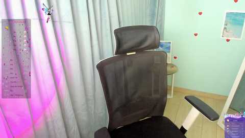 Media: A video of a black ergonomic office chair with a headrest against a mint-green wall, featuring a heart-themed poster and a calendar.