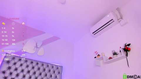 Media: Video of a cozy, pastel-toned bedroom with a tufted headboard, white shelves, an air conditioner, and a calendar. The room has a soft, ethereal ambiance with purple lighting.