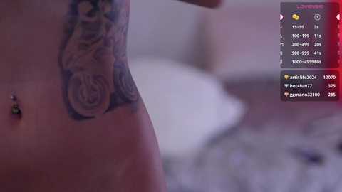 Media: A video of a close-up of a woman's bare torso, showcasing a detailed rose tattoo on her side, with a blurred bedroom background. The image is overlaid with social media comments and heart icons.