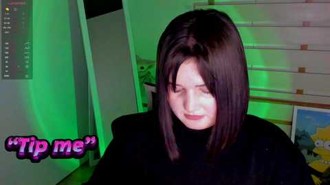 Media: Video of a woman with straight black hair, wearing a black turtleneck sweater, in a dimly lit room with greenish lighting. She appears to be in a playful, smirking pose.