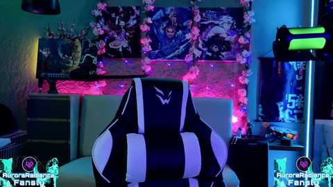 Media: Video of a gamer's room with a black-and-white striped gaming chair, a vibrant wall mural, neon lights, a TV, and a desk cluttered with gaming gear.