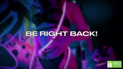 Media: Video of a colorful, abstract neon art piece with vibrant pink, purple, and blue hues. Text overlay reads, \"BE RIGHT BACK!\" in bold white letters. Background features a dark, blurred setting.