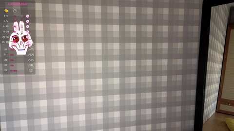 Media: Video of a gray checkered wall with a digital clock overlay, featuring a stylized, cartoonish white bunny with red eyes, and a partially open door to the right.