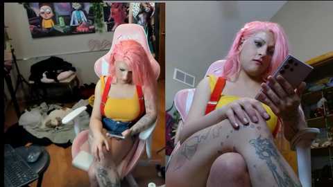 Media: Video of a plus-size woman with pink hair, tattoos, and a yellow crop top, sitting on a gaming chair in a messy room.