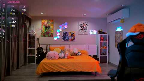 Media: A vibrant, modern bedroom with an orange bed, colorful wall decorations, plush toys, and a gaming chair, captured in a live-stream recording.