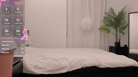 Media: Video of a minimalist bedroom with a white bed, white curtains, a green plant, and a digital temperature display overlay.