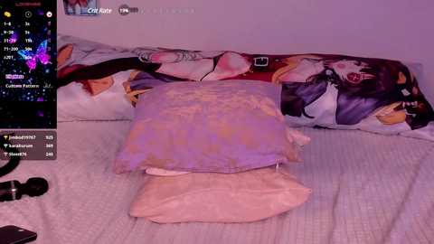 Media: A video of a bed with a cat pillow featuring anime characters, surrounded by colorful digital clocks and a laptop on the left.