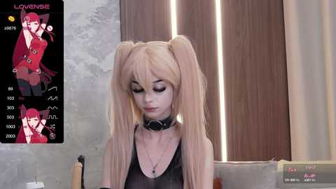 Media: A photo of a pale-skinned, slender woman with long blonde pigtails, wearing a black choker and a revealing black top, in front of a wooden wall. Left inset shows a \"Love Live!\" character.