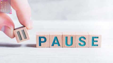 Media: Video of a hand holding a wooden letter \"P\" with a turquoise background, spelling \"PAUSE\" in wooden block letters on a light-colored surface.