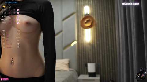 Media: Video of a topless woman with small breasts, black long-sleeve top pulled up, standing in a modern bedroom with grey curtains, bed, and lighting.