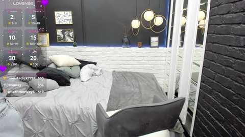 Media: Video of a modern bedroom with a gray bed, white brick wall, black brick wall, white window frame, and contemporary circular light fixture.