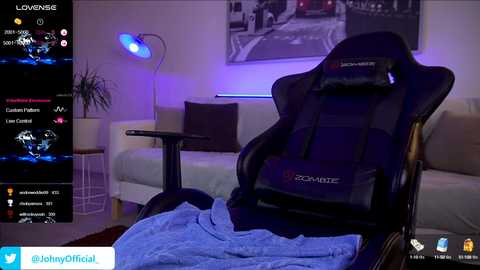 Media: Video of a modern living room with a black gaming chair, blue accent lighting, a white couch, and a large black-and-white cityscape print on the wall.