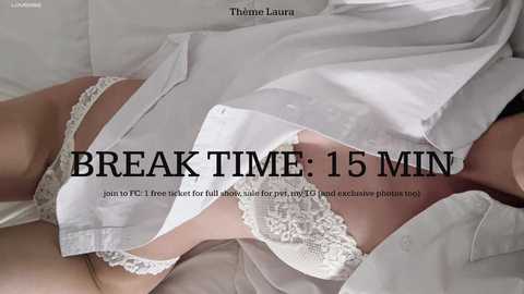 Media: A video featuring a woman in white lace lingerie, lying on a bed, with the text \"BREAK TIME: 15 MIN\" superimposed.