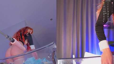 Media: Video of a woman with long red hair and a black mask, wearing a black and red plaid shirt, sitting on a glass table, holding a metal rod.