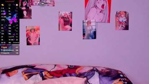 Media: A video of a bedroom wall with various anime posters, including a large one of a woman with long hair and red eyes, and a bed covered with a colorful, anime-themed comforter.