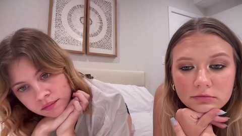 Media: Video of two young Caucasian women with light skin, long blonde hair, and makeup. One has acne and looks sad, while the other has clear skin and a neutral expression.