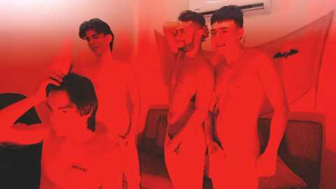 Media: Video of four shirtless young men, all with short dark hair, in a dimly lit room, bathed in red light, engaging in a playful, intimate moment.