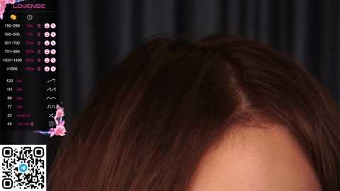 Media: A video captures a close-up of a woman's shoulder and head, showcasing long, straight brown hair. The background features a black curtain with a digital overlay displaying a social media platform.