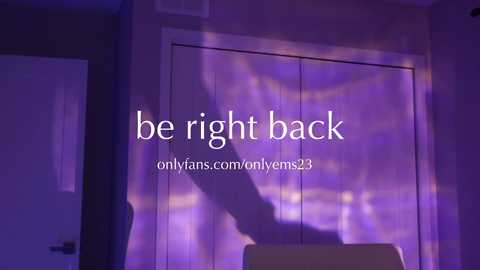 Media: A video of a dimly lit room with purple hues. A shadowy figure stands by a white door, casting a silhouette. The text \"be right back\" is overlaid in white.