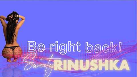 Media: Video: A woman with long, dark hair, wearing a black thong and fishnet stockings, stands with her back to the camera against a purple background. Text reads: \"Be right back!\" and \"Sweetly Riniushka.\