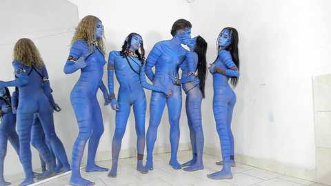 Media: Video of a group of blue-skinned, naked individuals in a white room, engaging in various interactions, including sexual acts, with their backs to a mirror.