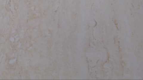 Media: Video of a textured, beige marble surface with subtle veining in pale hues of brown and white, showcasing a natural, elegant stone pattern.