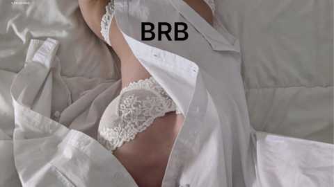 Media: A video of a person lying on a bed in white lingerie, with a partially unbuttoned white shirt. The image has the text \"BBR\" overlaid in bold black letters.