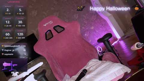 Media: A video of a pink gaming chair with a \"Happy Halloween\" overlay, surrounded by a cluttered room with a TV, controllers, and a laptop, featuring digital notifications and game stats.