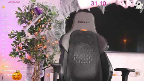 Media: Video of a dark gaming chair with a pumpkin-themed desk in the background, adorned with Halloween decorations, including a festive tree and orange lights.